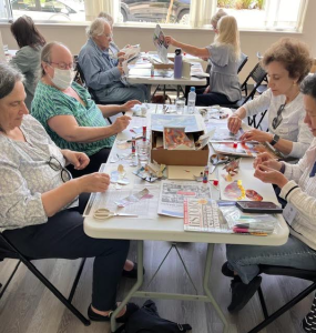 people doing collage around a table